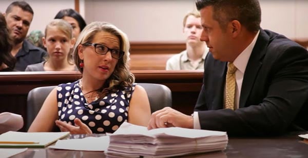 Attorney Eric L. Boehmer speaking with a client in the courtroom
