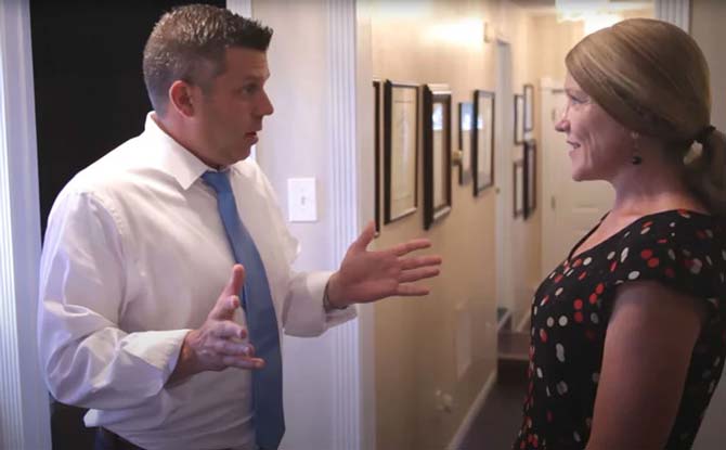 Attorney Eric L. Boehmer speaking with a client in the hallway